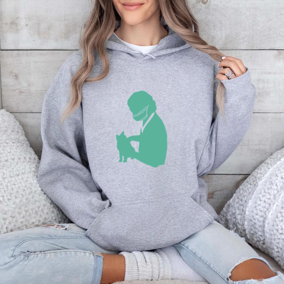 Silhouette Of A Veterinarian Holding A Cat In Green Hoodie